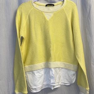 Yellow sweater with a layered shirt look.